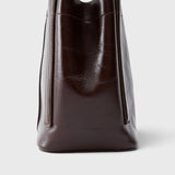 JONES + CO Bucket Tool bag in chestnut lustre leather with vertical paneling and sturdy elongated handles.