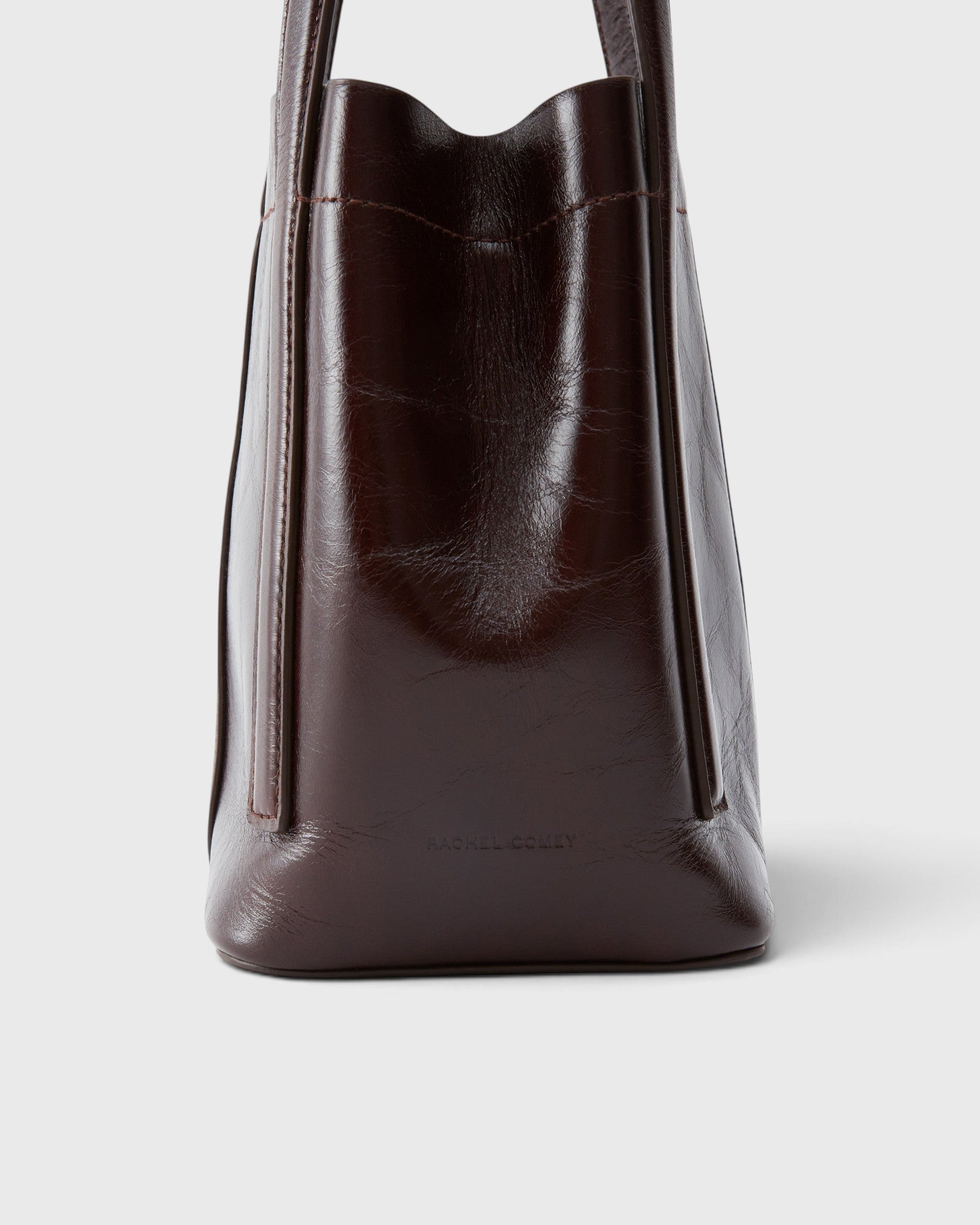 JONES + CO Bucket Tool bag in chestnut lustre leather with vertical paneling and sturdy elongated handles.