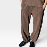 JONES + CO chocolate brown heavy cotton balloon pants with elastic cuffs and side pockets on a model