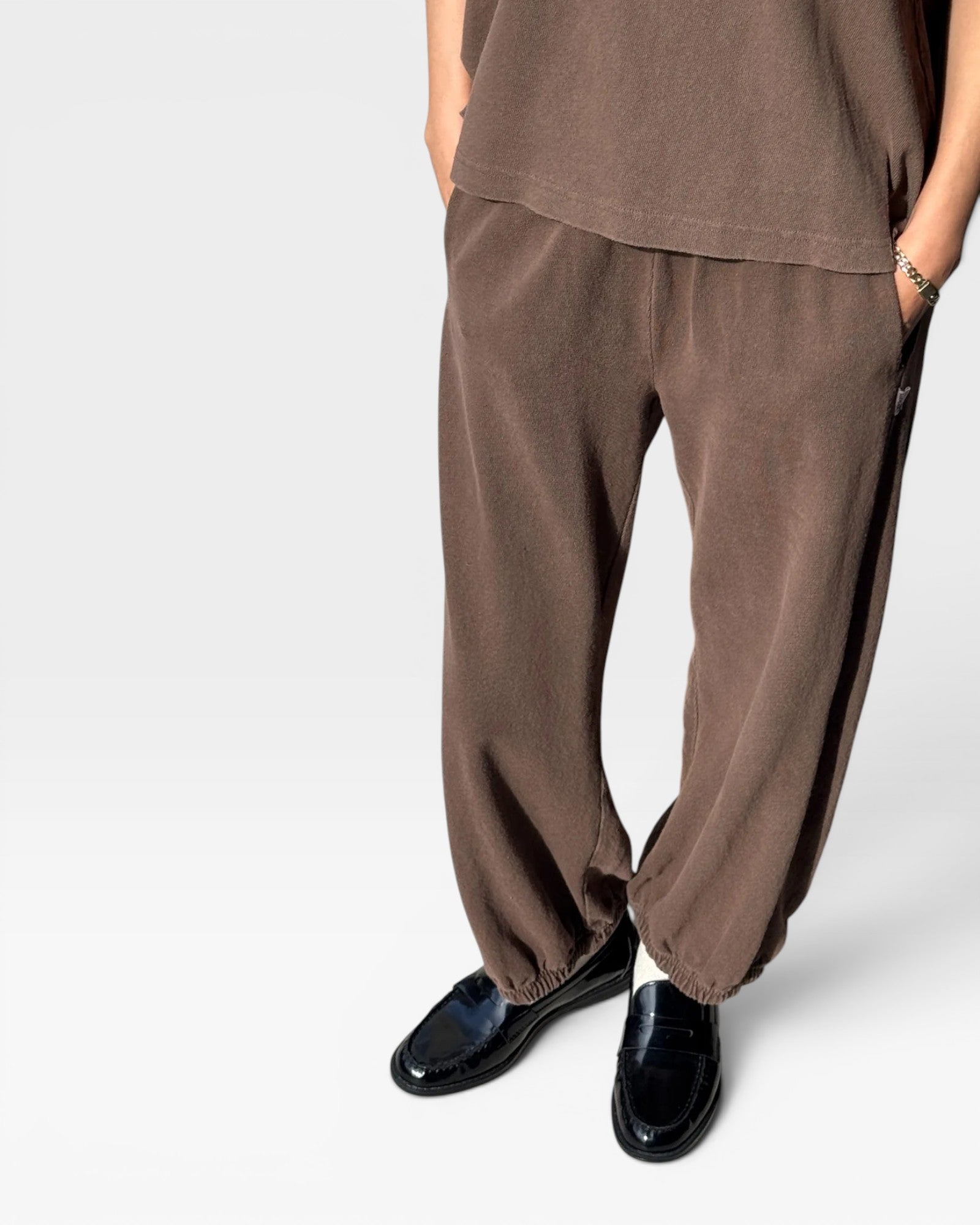 JONES + CO chocolate brown heavy cotton balloon pants with elastic cuffs and side pockets on a model