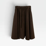 JONES + CO chocolate brown Angie skirt featuring an elastic drawstring waistband and a flowy midi silhouette.