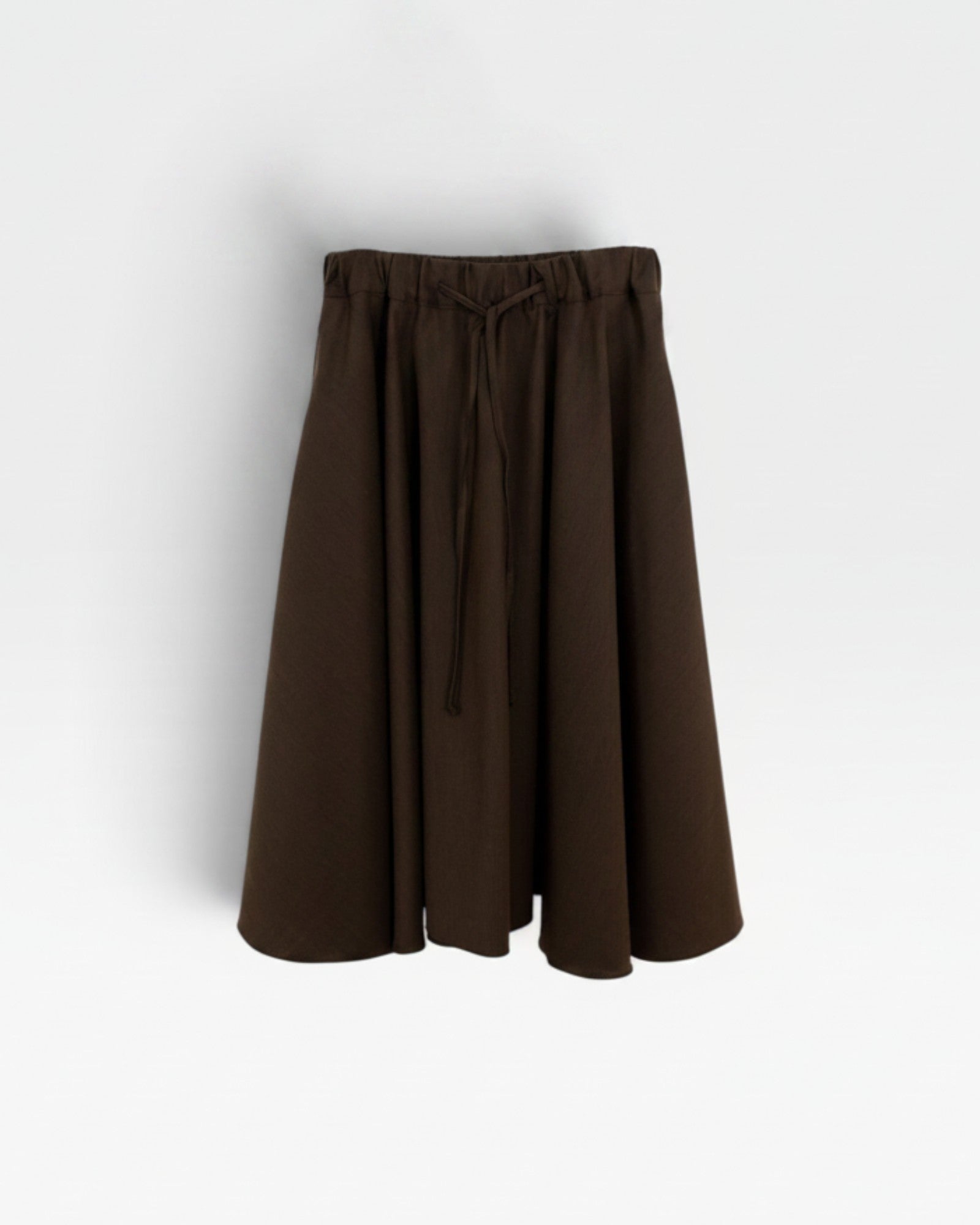 JONES + CO chocolate brown Angie skirt featuring an elastic drawstring waistband and a flowy midi silhouette.