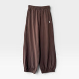 JONES + CO chocolate brown heavy cotton balloon pants with elastic cuffs and side pockets on a white background.