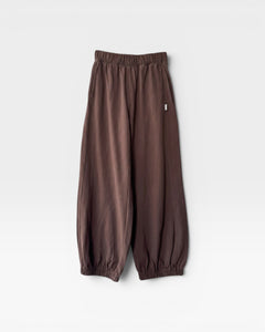 JONES + CO chocolate brown heavy cotton balloon pants with elastic cuffs and side pockets on a white background.