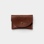 JONES + CO chocolate brown pebbled leather cardholder with a solid brass fastener, front view.