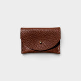 JONES + CO chocolate brown pebbled leather cardholder with a solid brass fastener, front view.