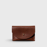 JONES + CO chocolate brown pebbled leather cardholder with a solid brass fastener, front view.