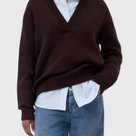 JONES + CO cinder brown wool-blend V-neck jumper with ribbed trims worn over a light blue striped shirt and jeans.