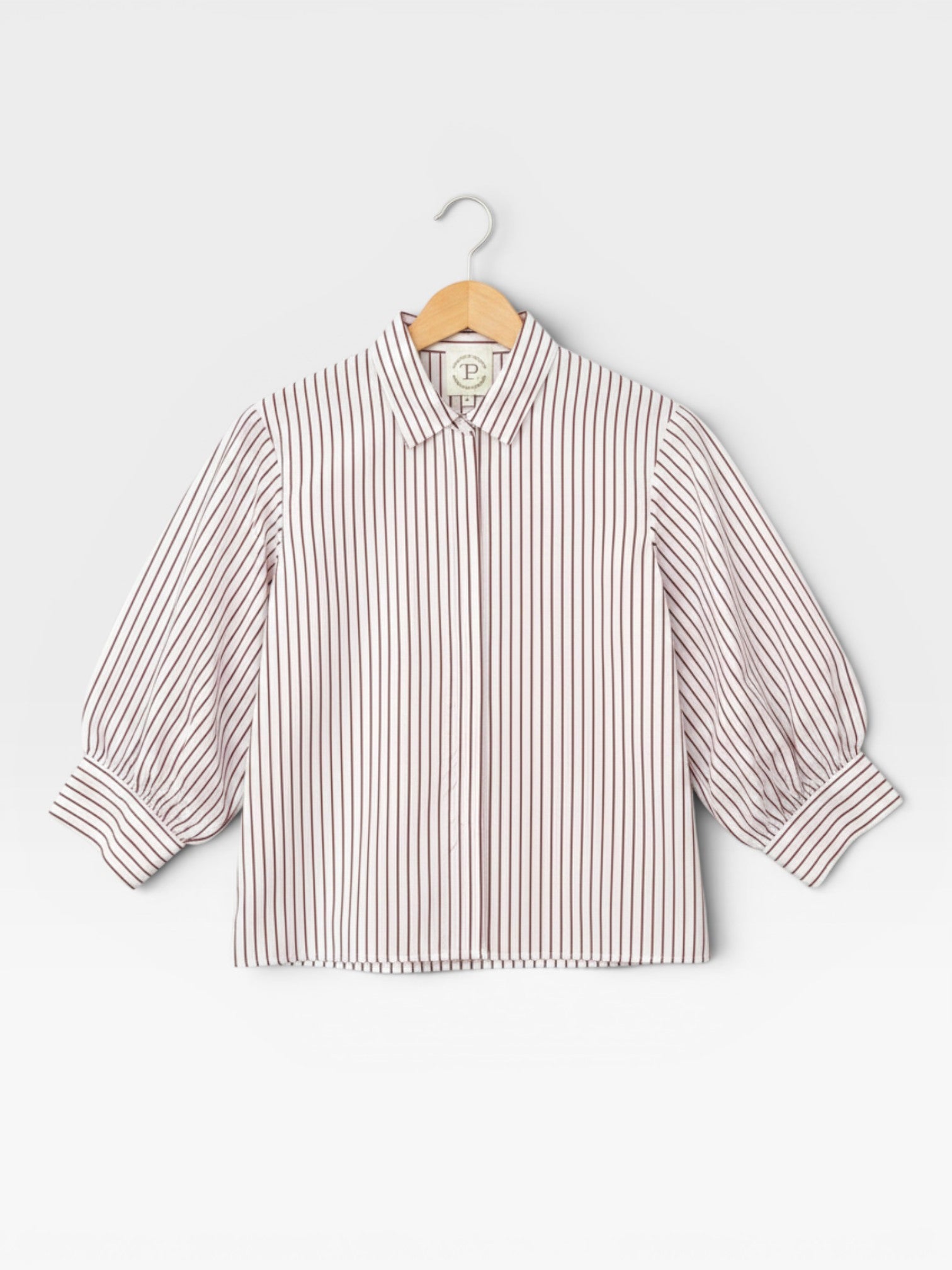 JONES + CO Esme Blouse in cinnamon stripe Spanish cotton poplin. Features lined puff sleeves, button-front, and pearl buttons.