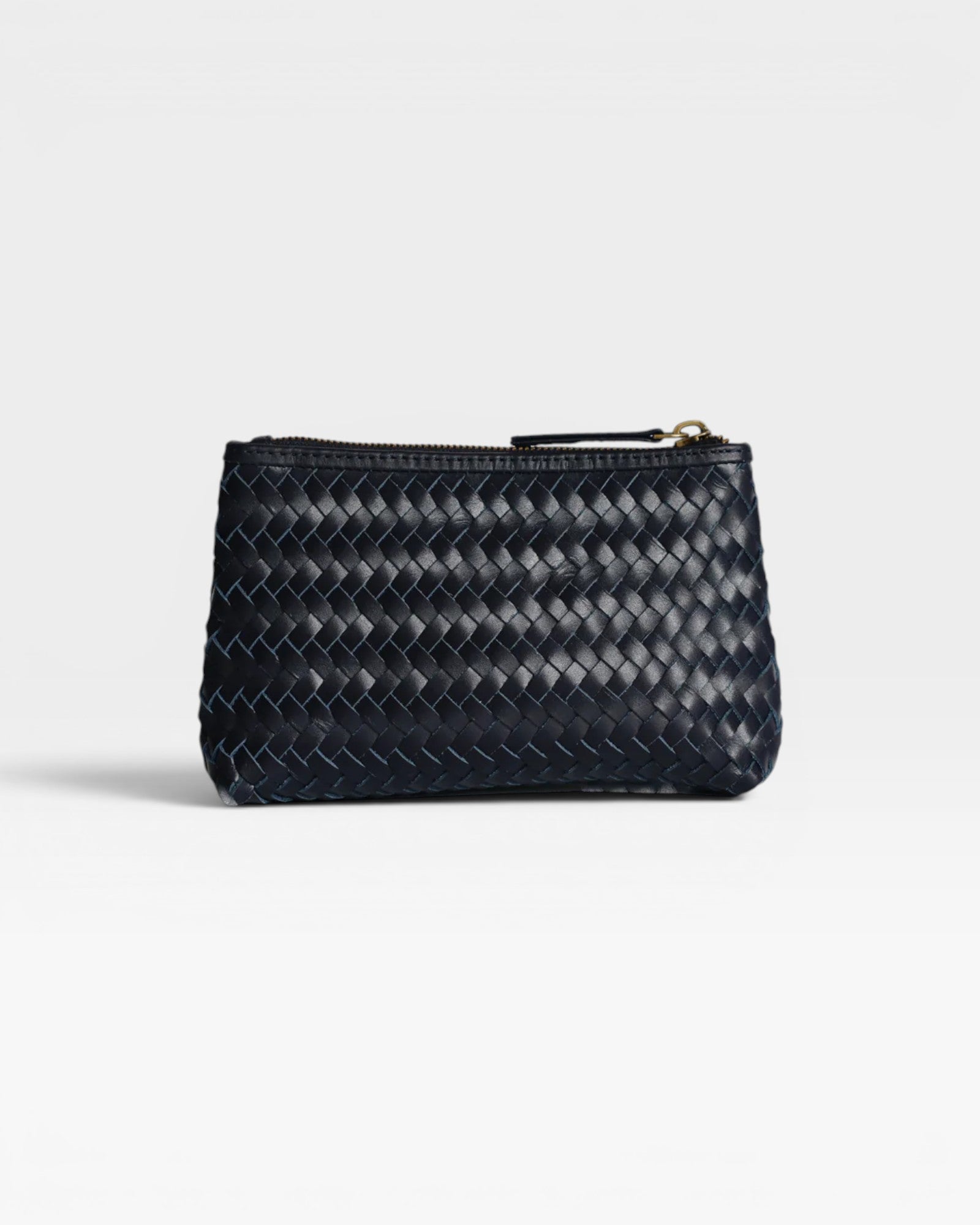 JONES + CO Cleo Pouch: small dark navy woven leather zip pouch for organizing essentials.