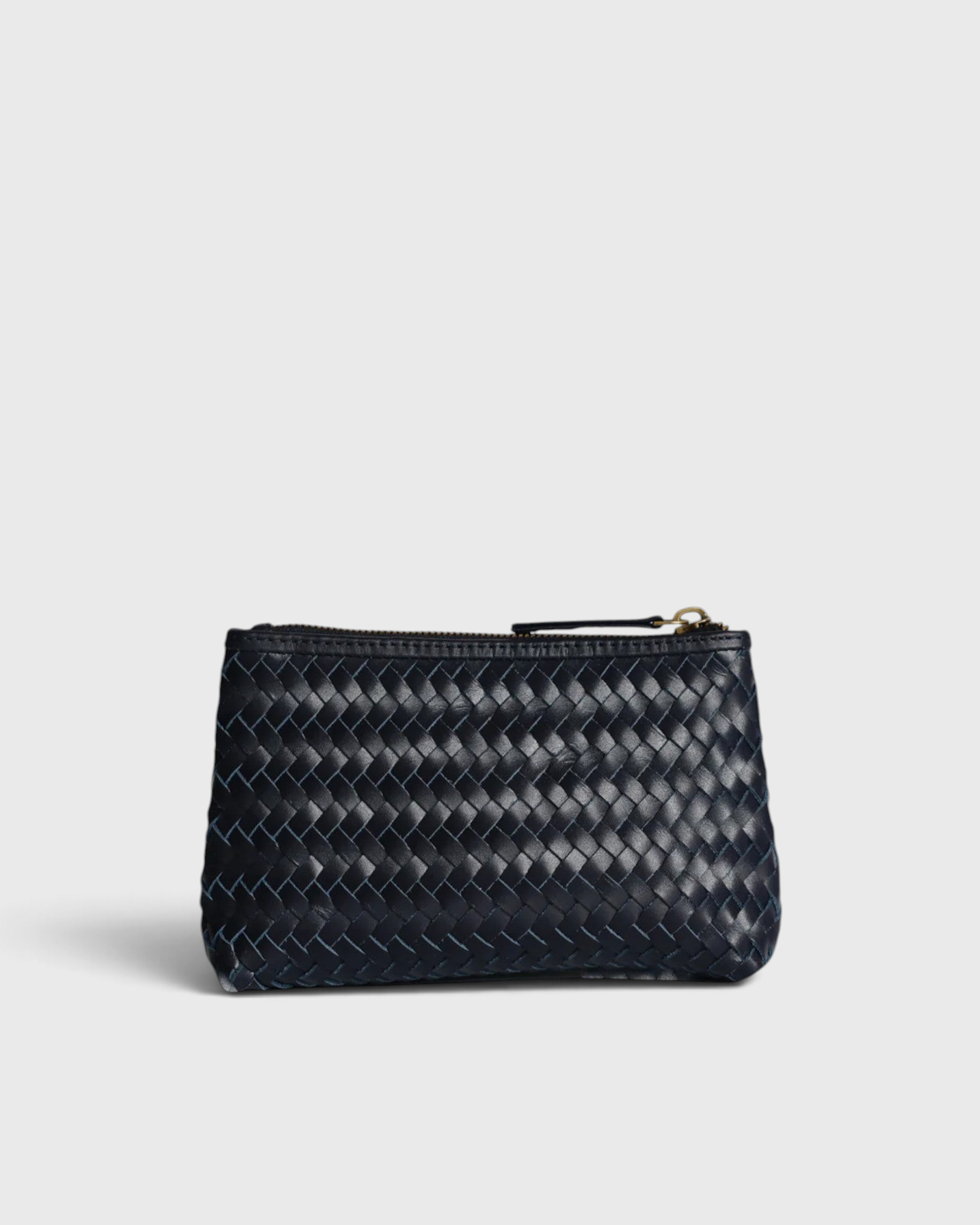 JONES + CO Cleo Pouch: small dark navy woven leather zip pouch for organizing essentials.