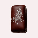JONES + CO dark chocolate bar with coconut and cashew, topped with shredded coconut flakes.