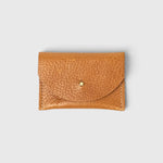 JONES + CO cognac leather cardholder with a pebbled texture and a simple brass stud closure.