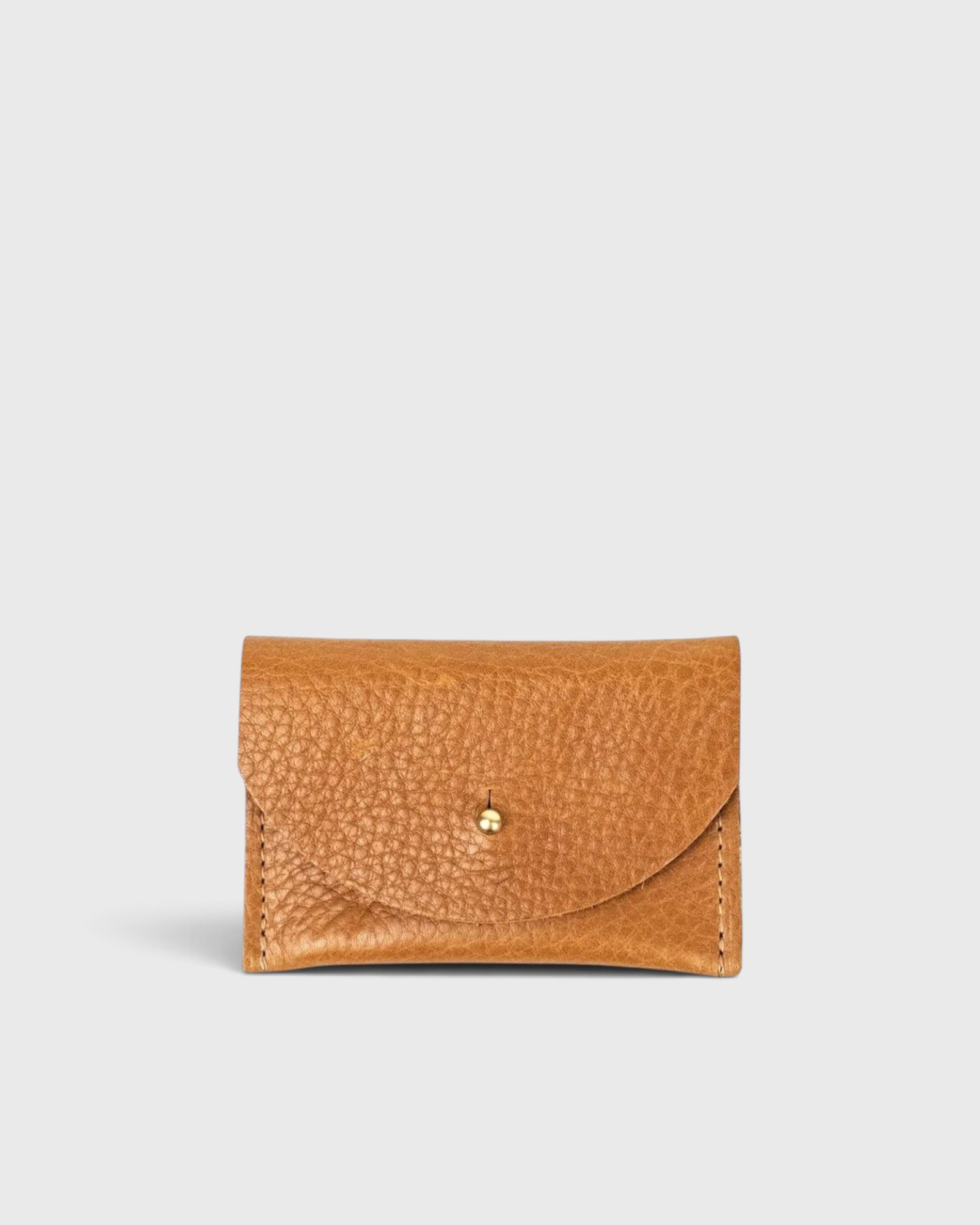 JONES + CO cognac leather cardholder with a pebbled texture and a simple brass stud closure.