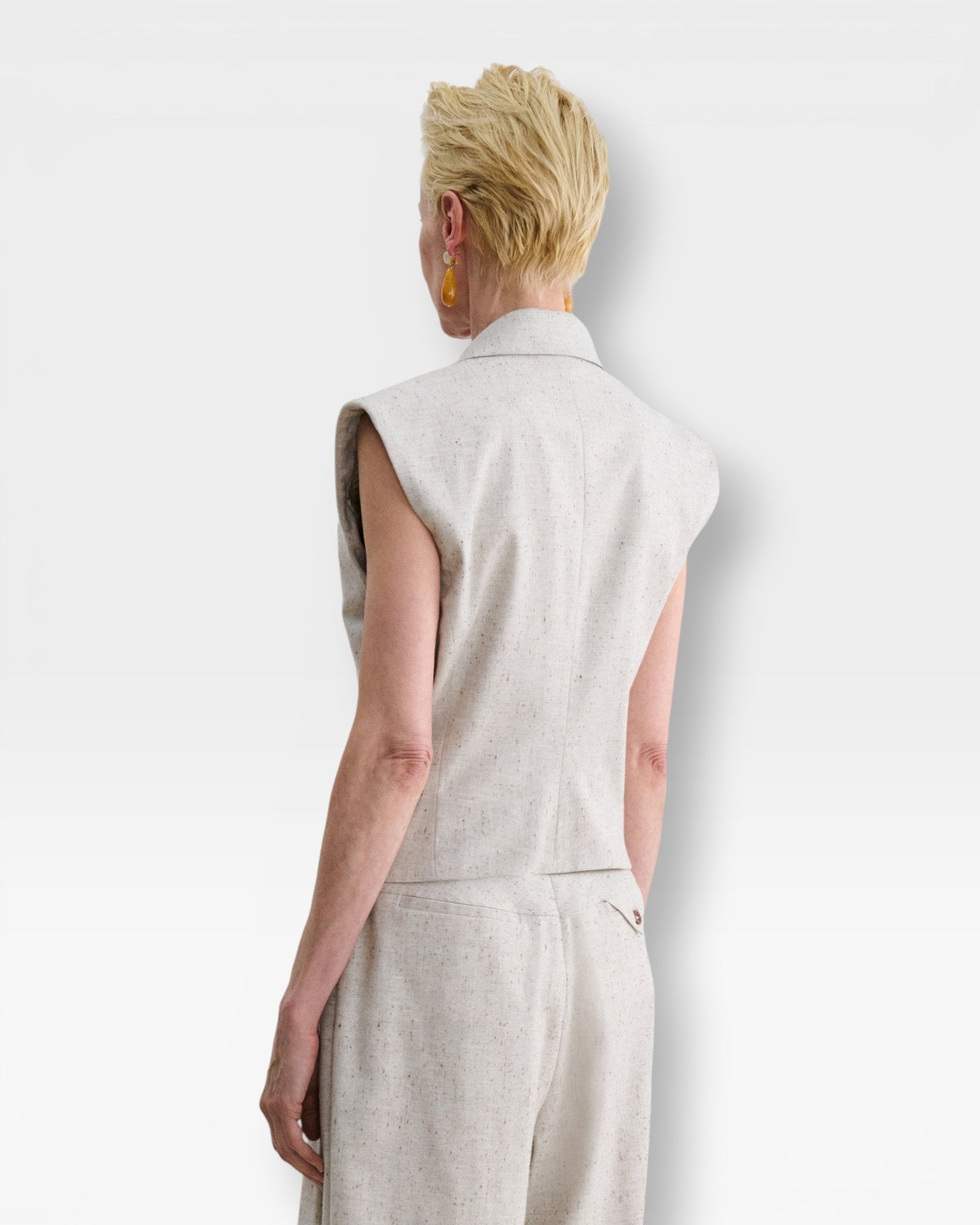 JONES + CO Comeau grey speckled double-breasted vest with peak lapels, shown from the back on a model.