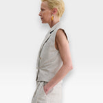 JONES + CO Comeau grey speckled double-breasted vest with peak lapels worn by a model in profile view.