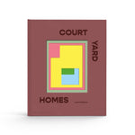 JONES + CO Courtyard Homes hardcover book featuring a minimalist geometric cover design in muted red, yellow, and blue.