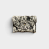 JONES + CO salt and pepper cowhide cardholder with a solid brass fastener, shown from a front view.