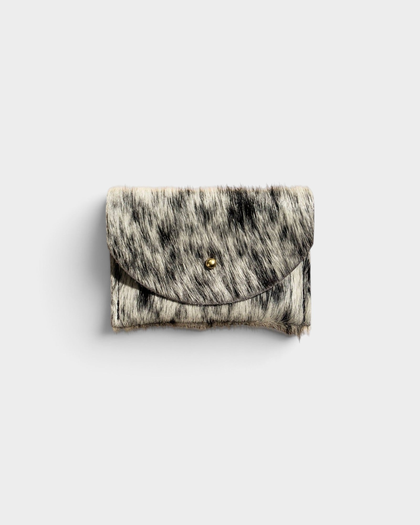 JONES + CO salt and pepper cowhide cardholder with a solid brass fastener, shown from a front view.