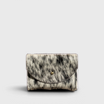 JONES + CO salt and pepper cowhide cardholder with a solid brass fastener, shown from a front view.