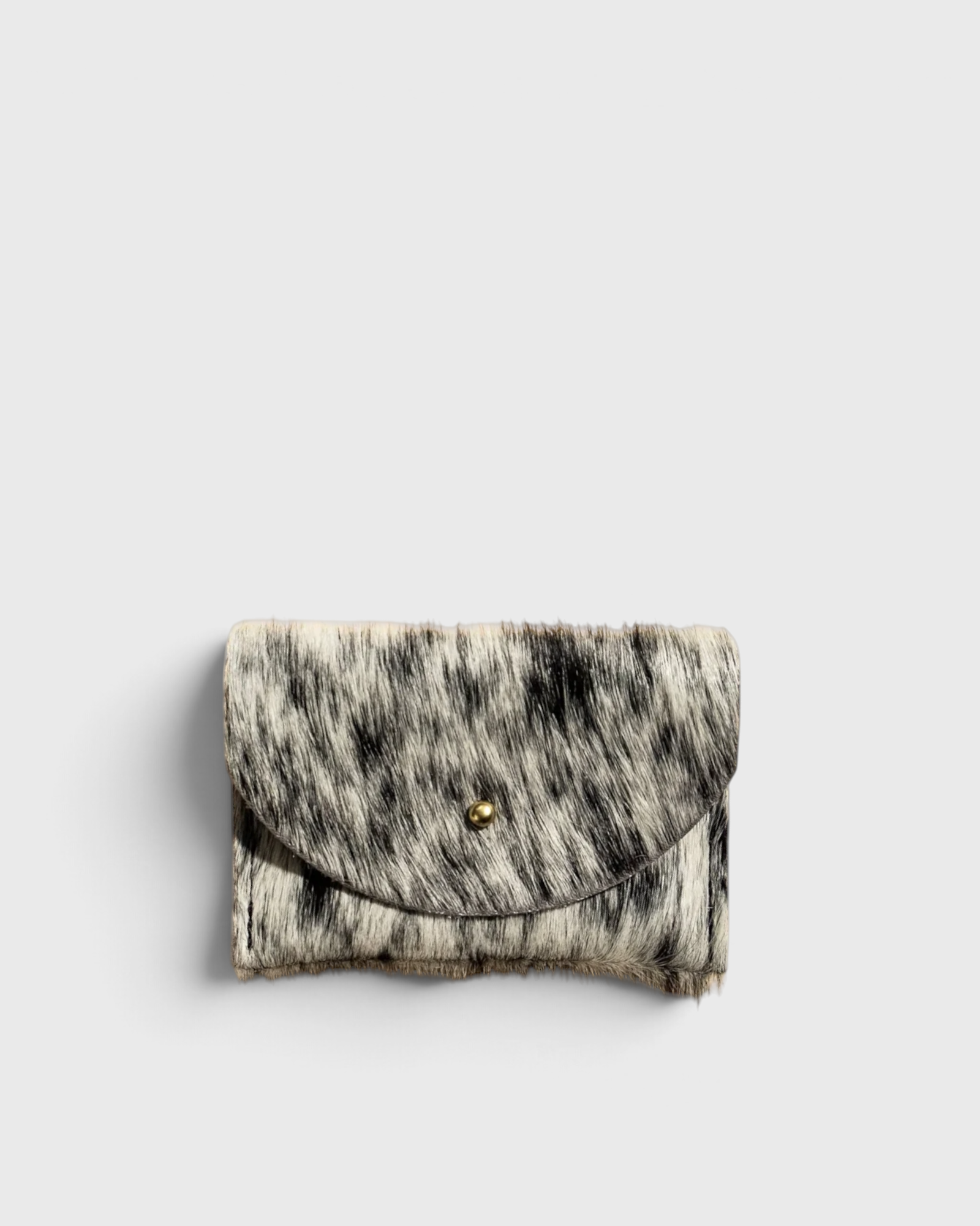 JONES + CO salt and pepper cowhide cardholder with a gold snap button closure on a neutral background
