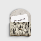 JONES + CO salt and pepper cowhide cardholder with a gold snap closure on a neutral background