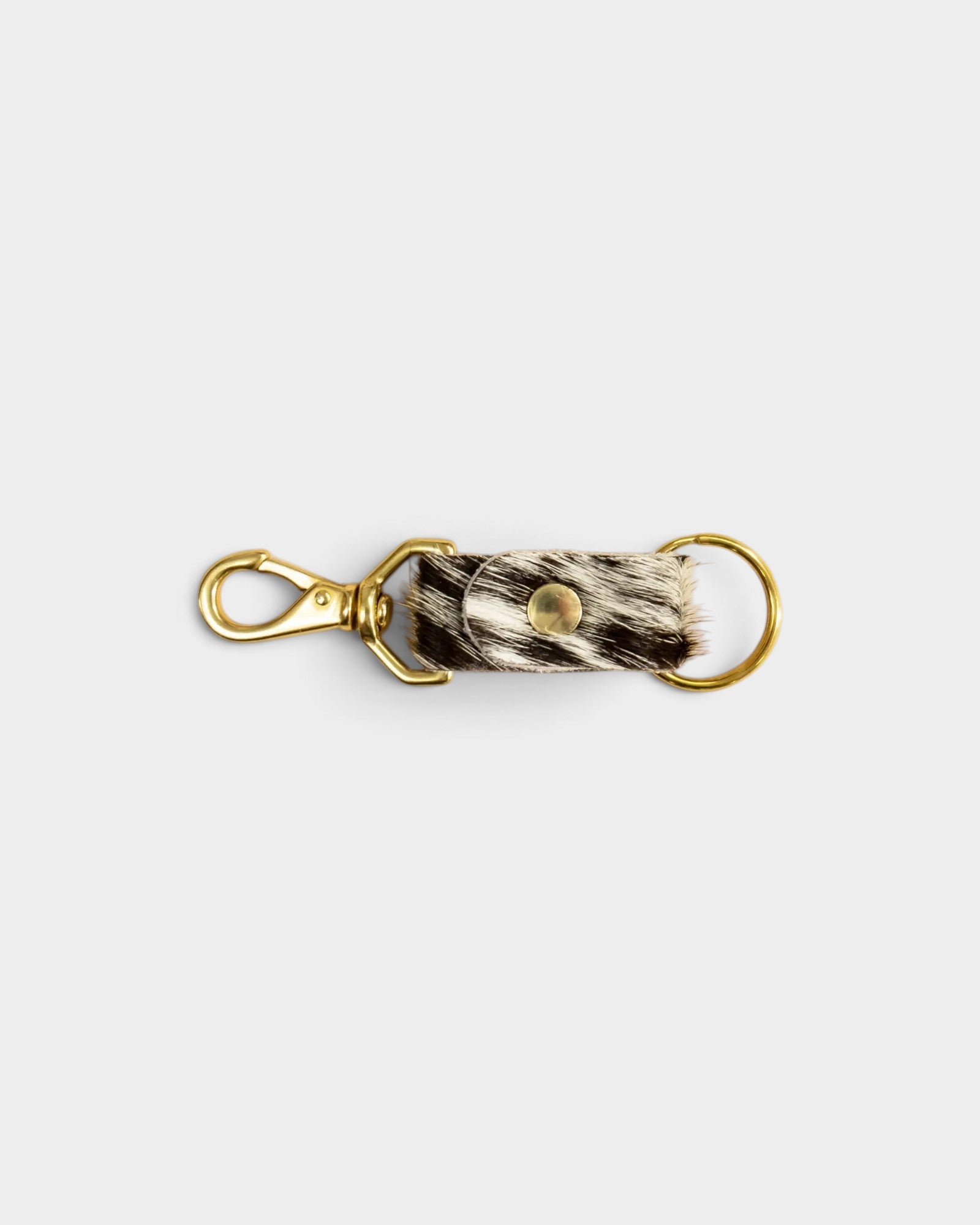 JONES + CO salt and pepper cowhide keychain with gold-tone metal hardware and a secure lobster clasp.