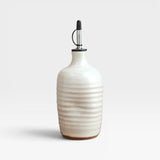 JONES + CO handmade cream stoneware olive oil cruet with a ribbed texture and black pourer spout
