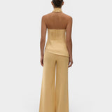 JONES + CO Syna wide-leg linen pants in daffodil yellow worn with a matching halter top, back view.
