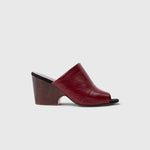JONES + CO Dahl sculptural wedge mule in scarlet shiny leather with an angular peep toe and wooden heel.