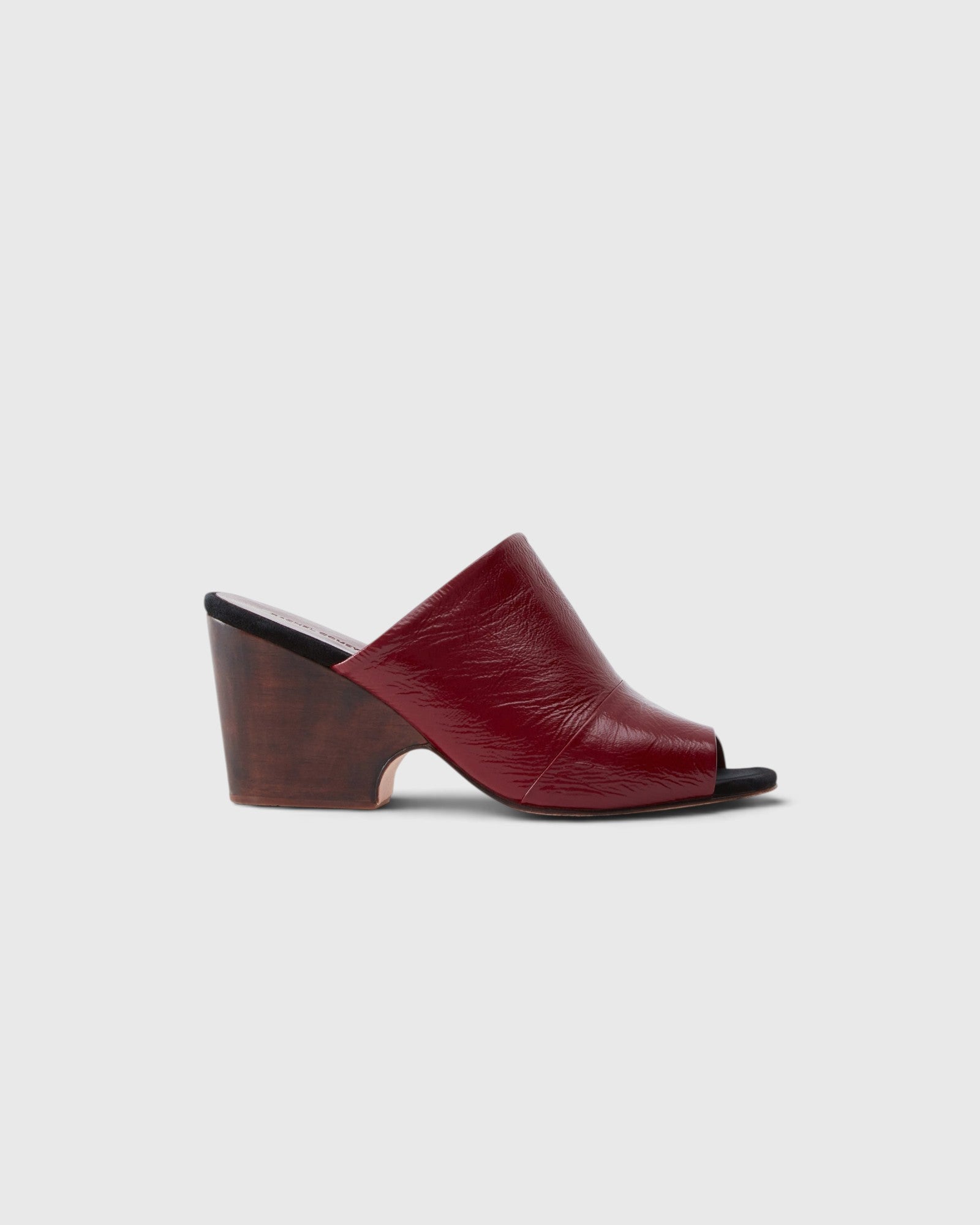 JONES + CO Dahl sculptural wedge mule in scarlet shiny leather with an angular peep toe and wooden heel.