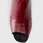 JONES + CO Dahl scarlet leather wedge mule with a sculptural silhouette and angular peep toe design.