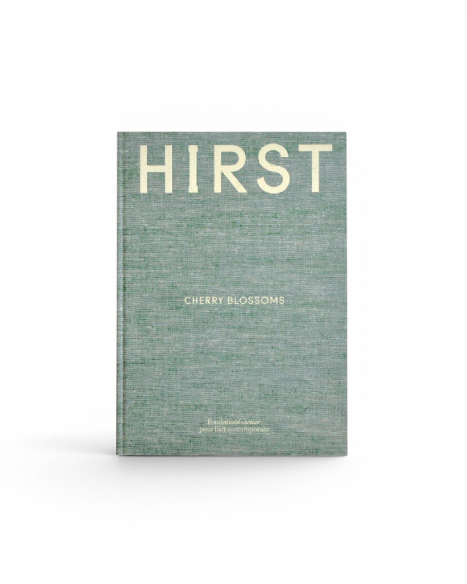 JONES + CO Damien Hirst Cherry Blossoms exhibition book with a textured green linen cover and white typography.
