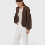 JONES + CO dark brown chunky alpaca bomber cardigan with a textured pearl knit pattern worn by a woman