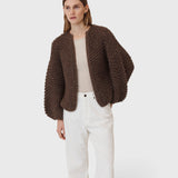 JONES + CO dark brown chunky alpaca bomber cardigan with a textured pearl knit pattern worn by a model