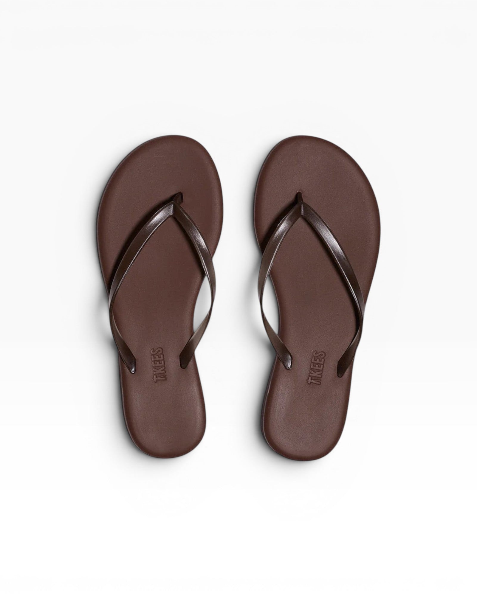 JONES + CO dark brown PVC flip-flop sandals with thin straps, perfect for beach days.
