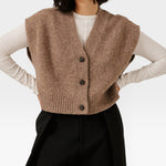 JONES + CO dark fawn cropped button-down vest in a soft alpaca and merino wool blend layered over a white shirt.
