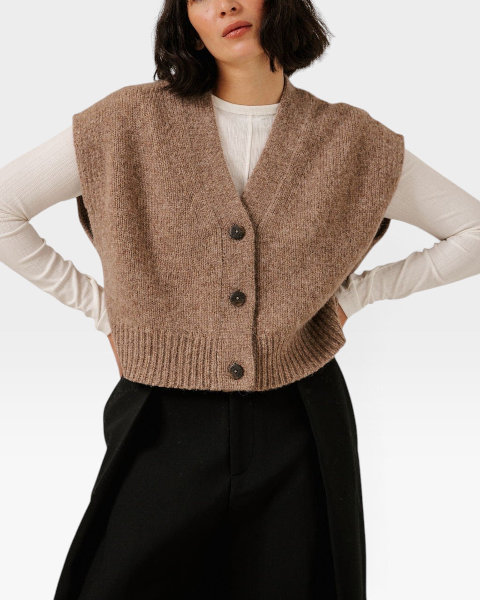 JONES + CO dark fawn cropped button-down vest in a soft alpaca and merino wool blend layered over a white shirt.