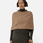 JONES + CO seamless dark fawn alpaca-blend poncho worn over a charcoal turtleneck and skirt