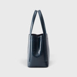 JONES + CO Bucket Tool bag in dark indigo lustre leather with vertical paneling and elongated handles, side view.