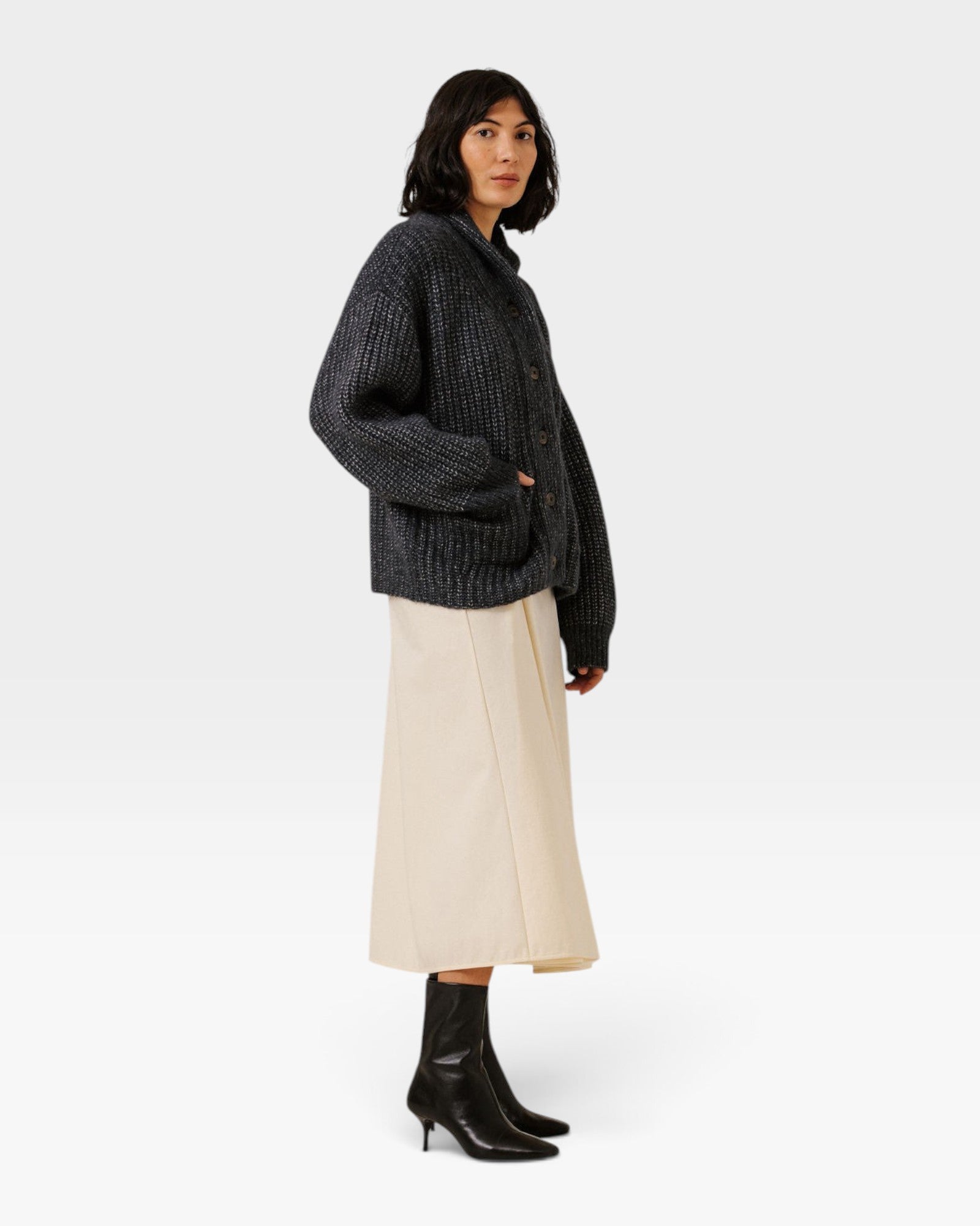 JONES + CO dark navy oversized shawl-collar cardigan in alpaca and cotton blend worn by a model with a cream skirt.