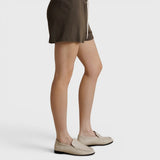 JONES + CO dark olive French terry lounge shorts with an elastic waistband, drawcord, and raw edge hem, side view.