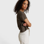 Model wearing a JONES + CO dark olive recycled cotton Alanis V-neck tee with a relaxed cropped fit