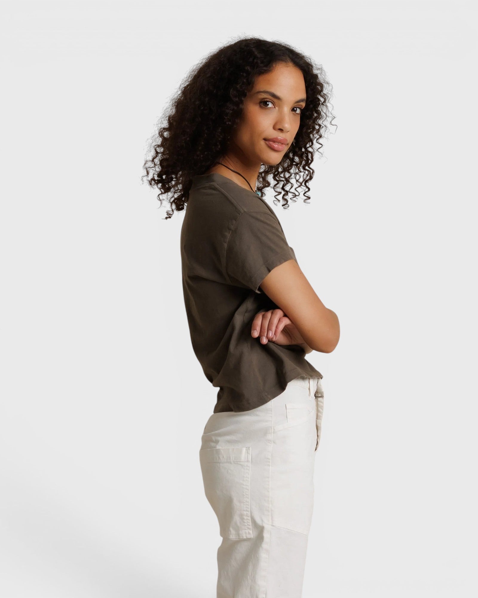 Model wearing a JONES + CO dark olive recycled cotton Alanis V-neck tee with a relaxed cropped fit