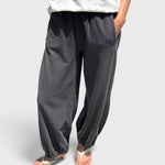 JONES + CO dark slate balloon pants with high elastic waist, side pockets, and gathered cuffs on a model