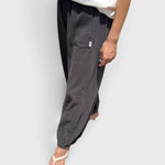 JONES + CO dark slate balloon pants with elastic cuffs, high waist, and side pockets worn with white sandals
