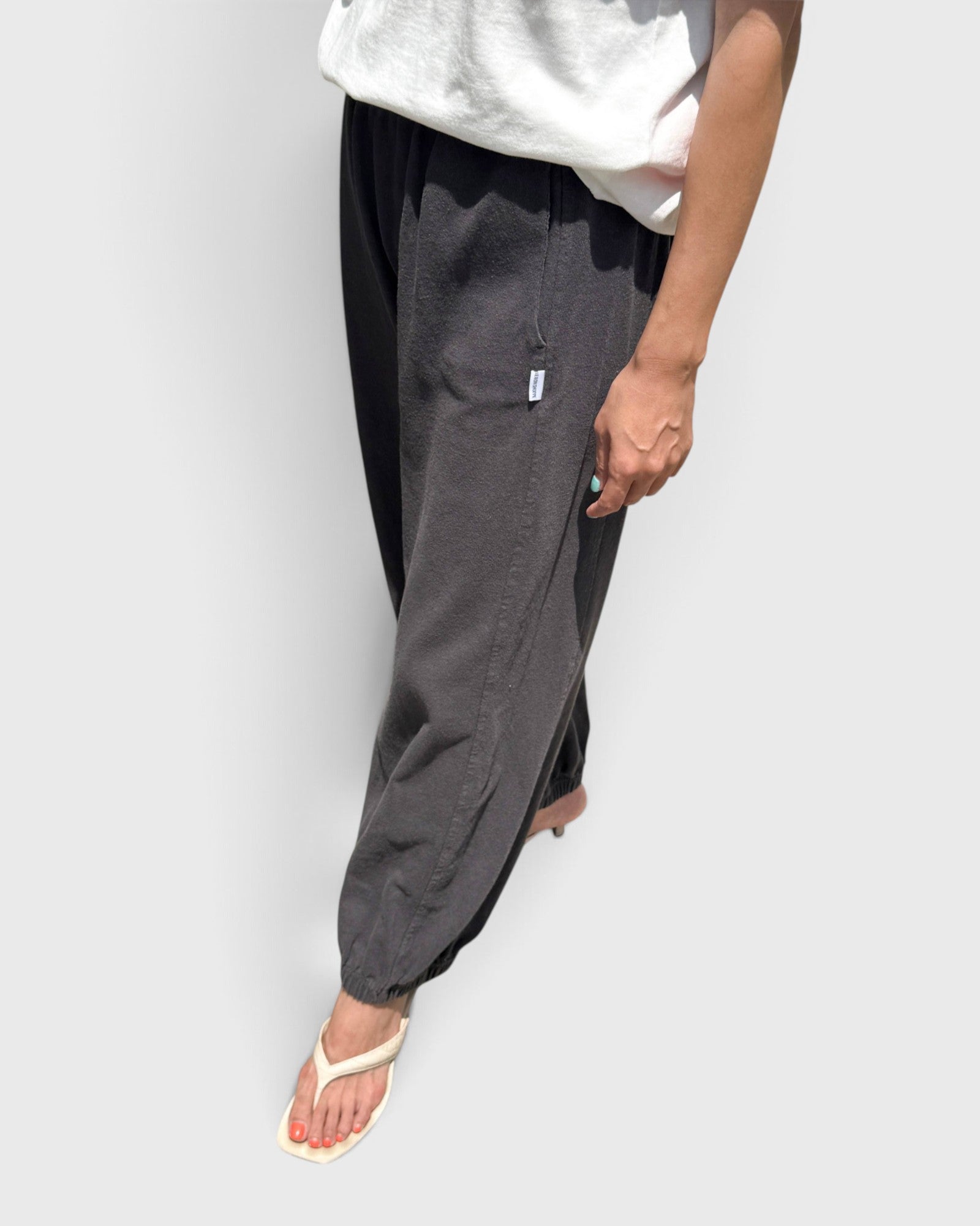 JONES + CO dark slate balloon pants with elastic cuffs, high waist, and side pockets worn with white sandals