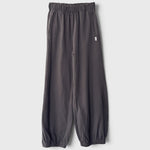JONES + CO dark slate balloon pants with a high elastic waist, side pockets, and gathered elastic leg openings.