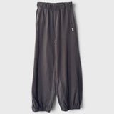 JONES + CO dark slate balloon pants with a high elastic waist, side pockets, and gathered elastic leg openings.