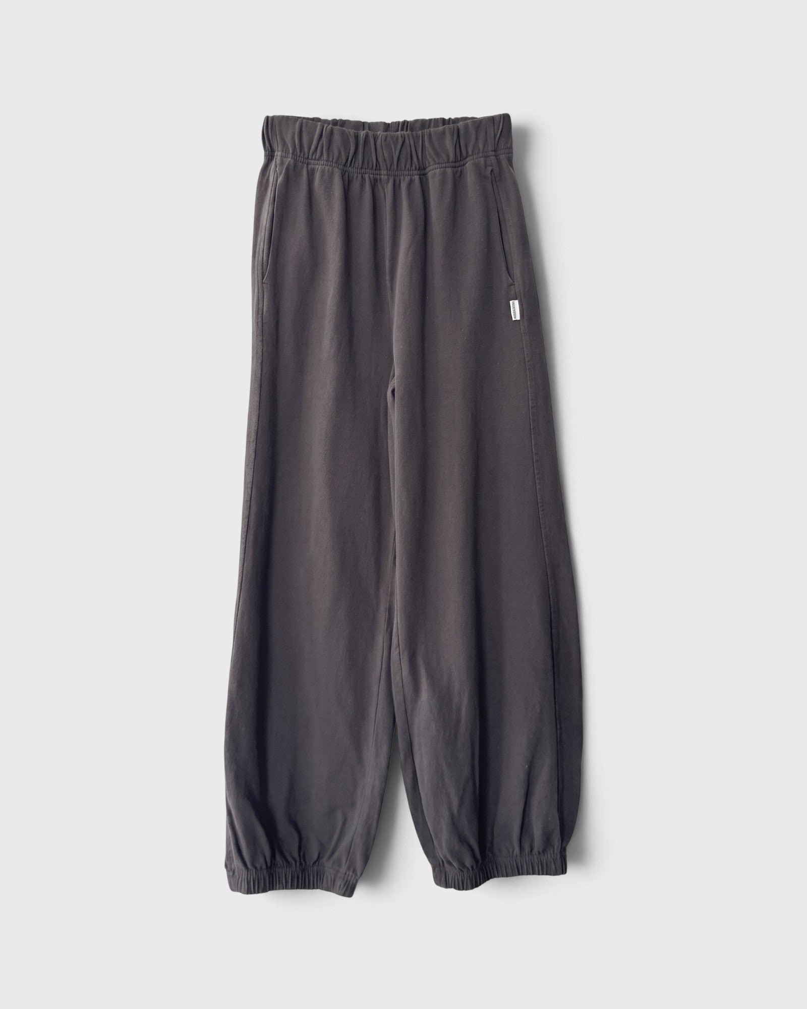 JONES + CO dark slate balloon pants with a high elastic waist, side pockets, and gathered elastic leg openings.
